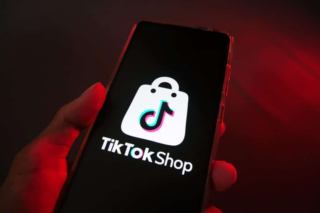 The TikTok Shop logo. Credit: Shutterstock/Ka Iki. An image of the TikTok Shop logo on a smartphone.