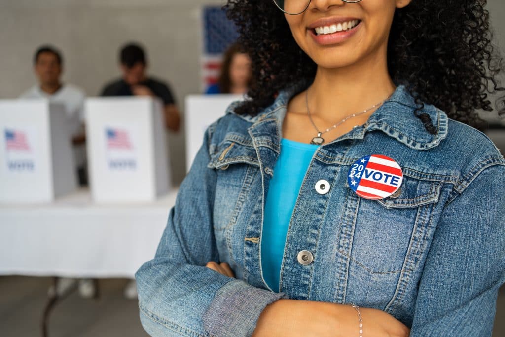 Young woman wearing 'I Voted' pin