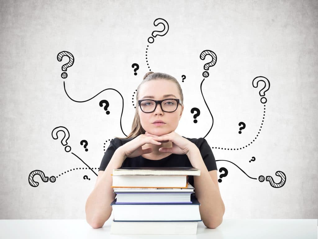 Serious young woman feeling lost in college.