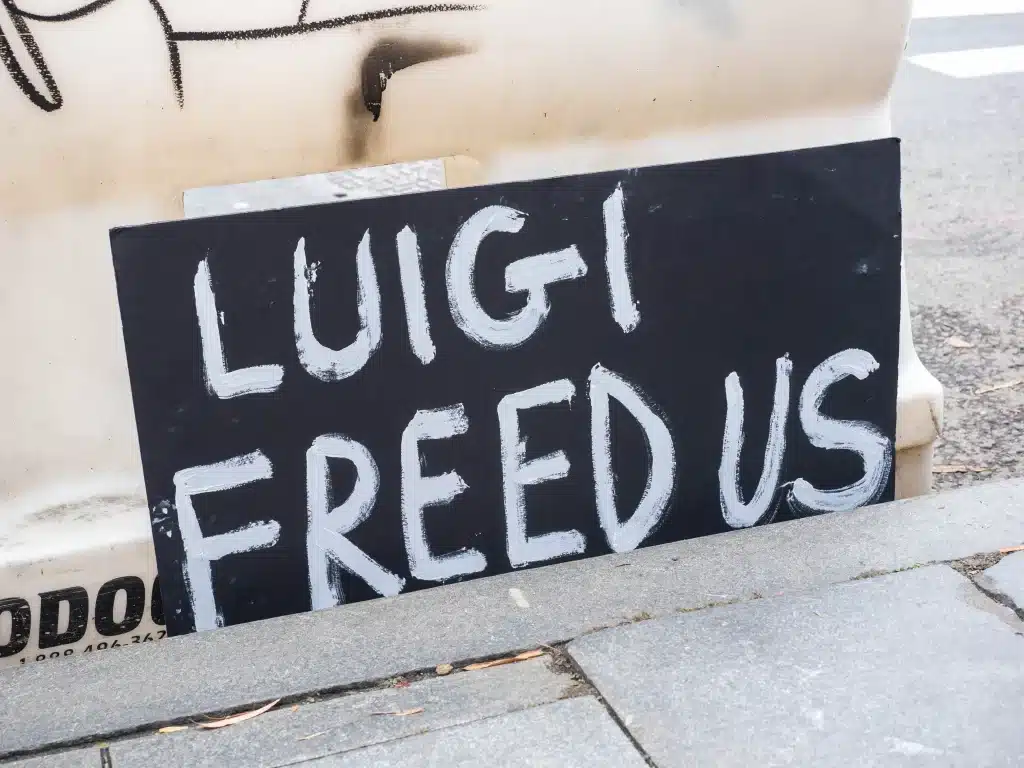 A sign put next to the sidewalk reads "Luigi Freed Us". Credit: Carlos Chiossone/ZUMA Press Wire/Shutterstock