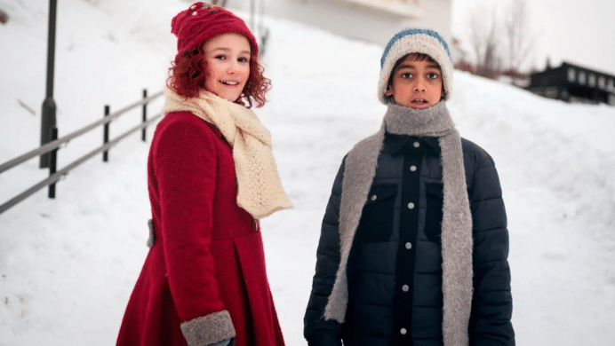 a girl and boy gaze at us in wonder.