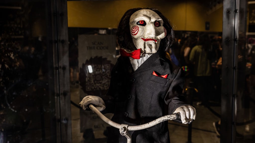 Billy the Puppet rides a tricycle in Saw.