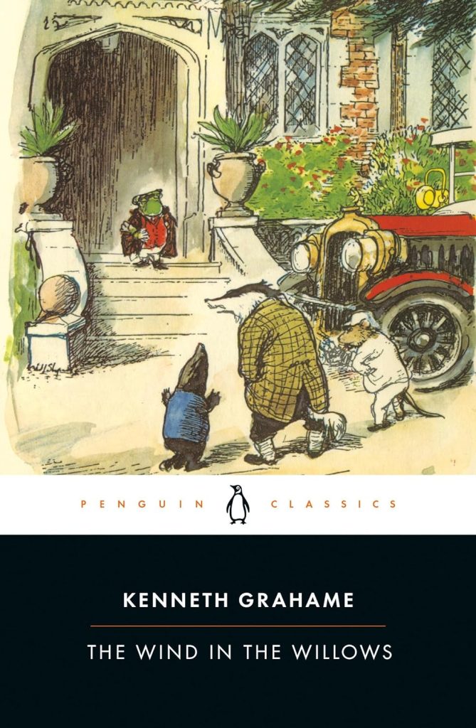 photo of book cover. penguin classic format with an illustration set above a white banner above a blue banner with the title and authors name on it. the illustration is of a scene from the book with a small smartly dressed toad walking out of his grand estate onto the front steps where a badger, rat, and mole, all in human clothes, stand waiting for him. next to them is Mr Toad's famous motorcar