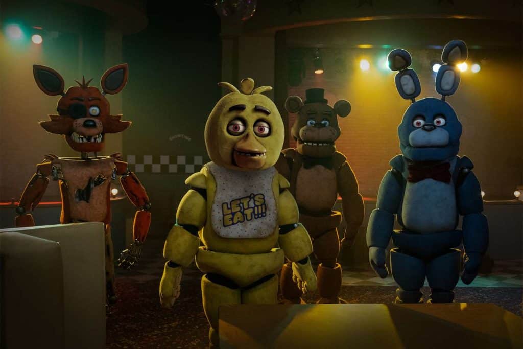 The animatronics of Five Nights at Freddy's stand together and stare into the camera.