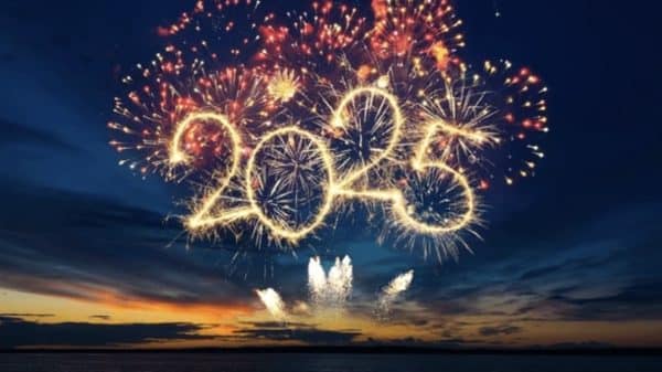 Image of fireworks in the shape of '2025' over blue water.