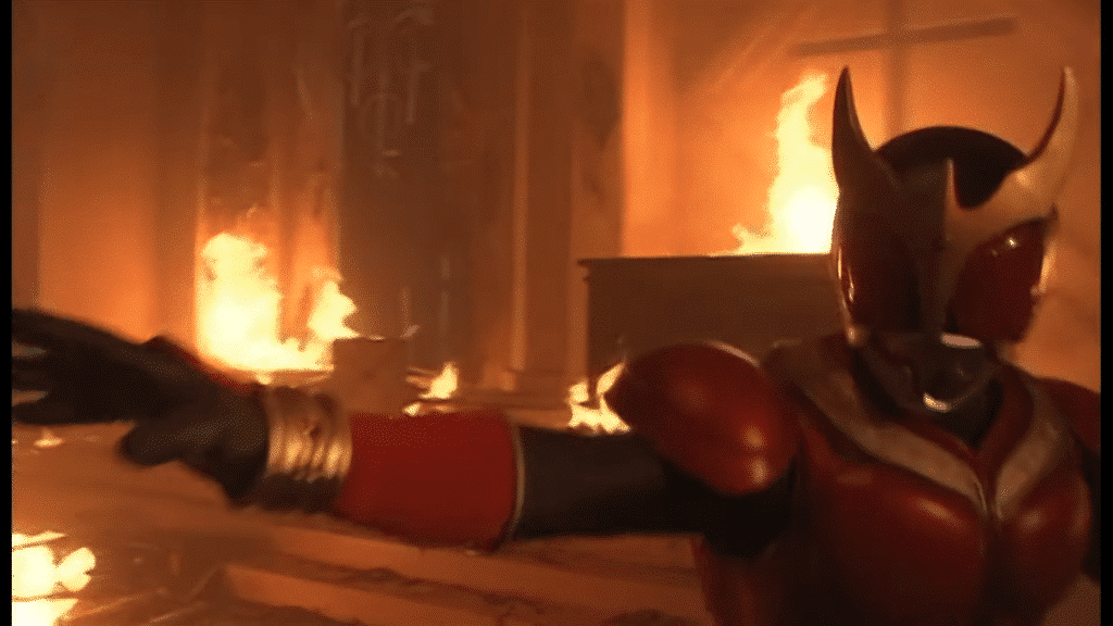 Kamen Rider Kuuga takes a fighting stance in a burning church.