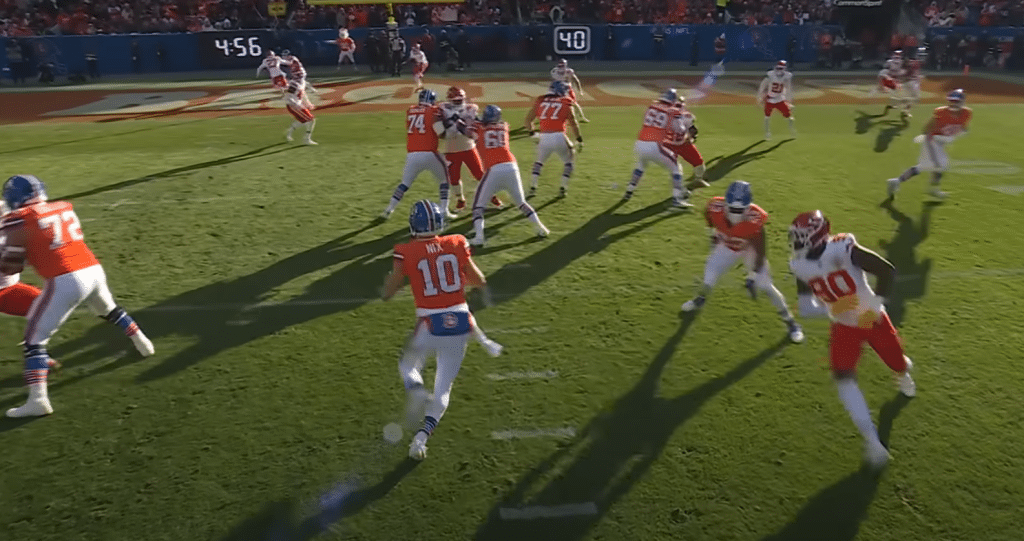 Broncos quarterback Bo Nix scrambles around looking for a receiver in the endzone against the chiefs.