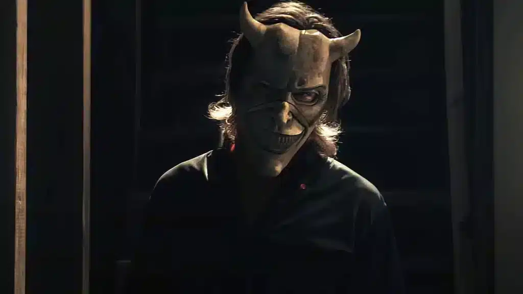 The Grabber, portrayed by Ethan Hawke, menacingly looks into the camera with a terrifying mask. 