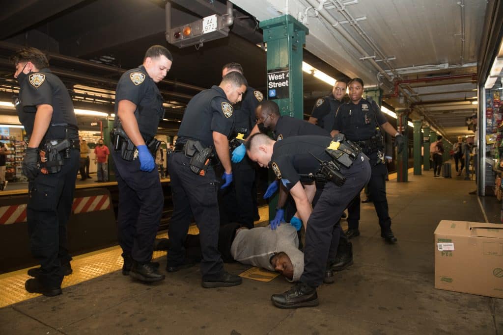 Homeless man blocking subway traffic on rails and trying to escape from the police. Credit: Nick Starichenko/Shutterstock