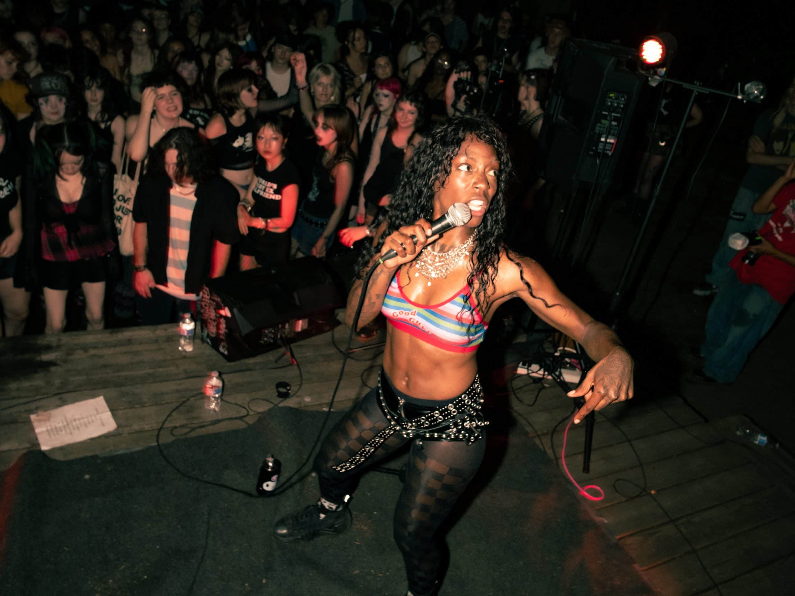 A photo of TeZATalks performing in front of a crowd at a music show.