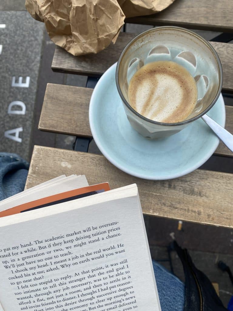 An open book and a coffee.