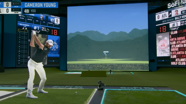 TGL player during a swing into the 150-foot simulator screen.