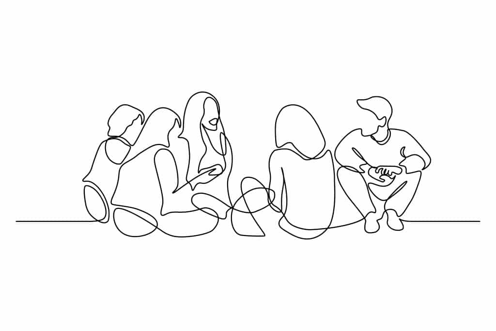 A group of friends sitting in a circle to show that not all families are related by blood.
