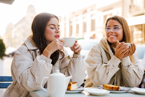 Two young women having coffee together