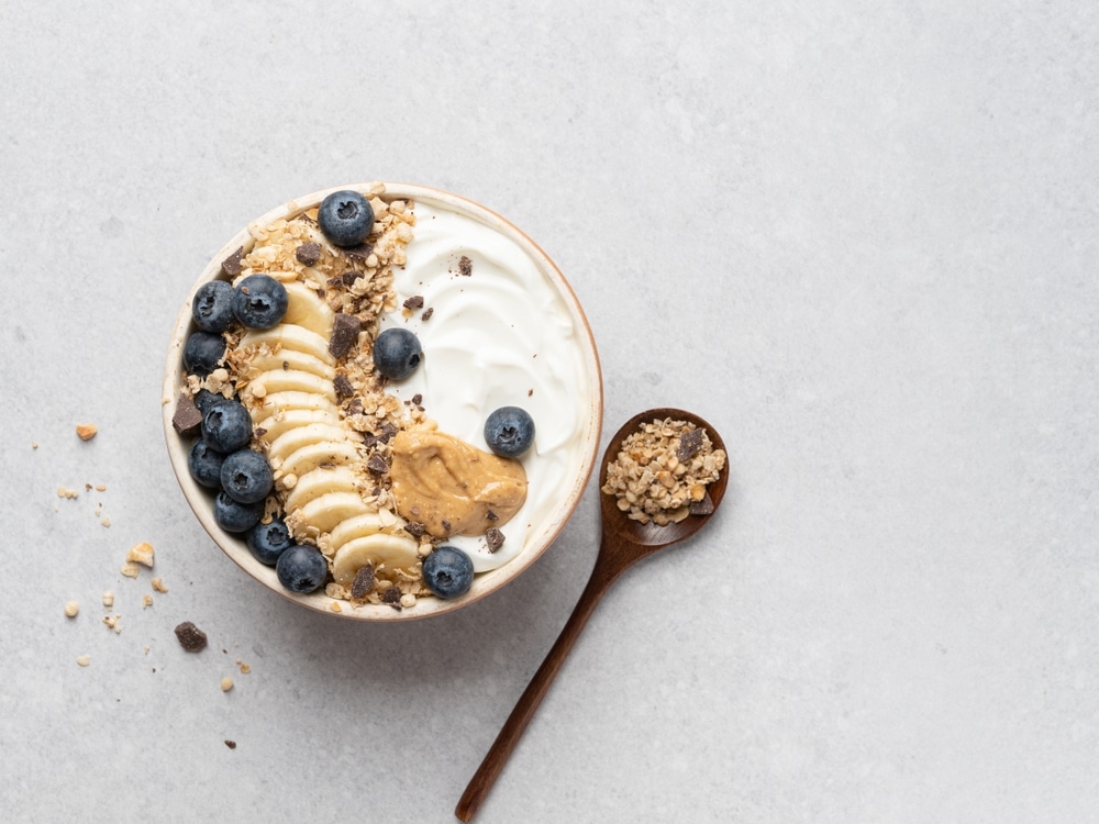 Photo of a Greek yogurt bowl with granola, berries, and other toppings.