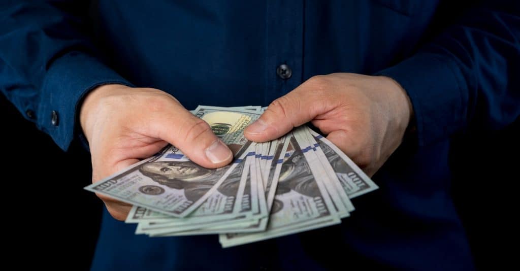 someone holding money in their hands