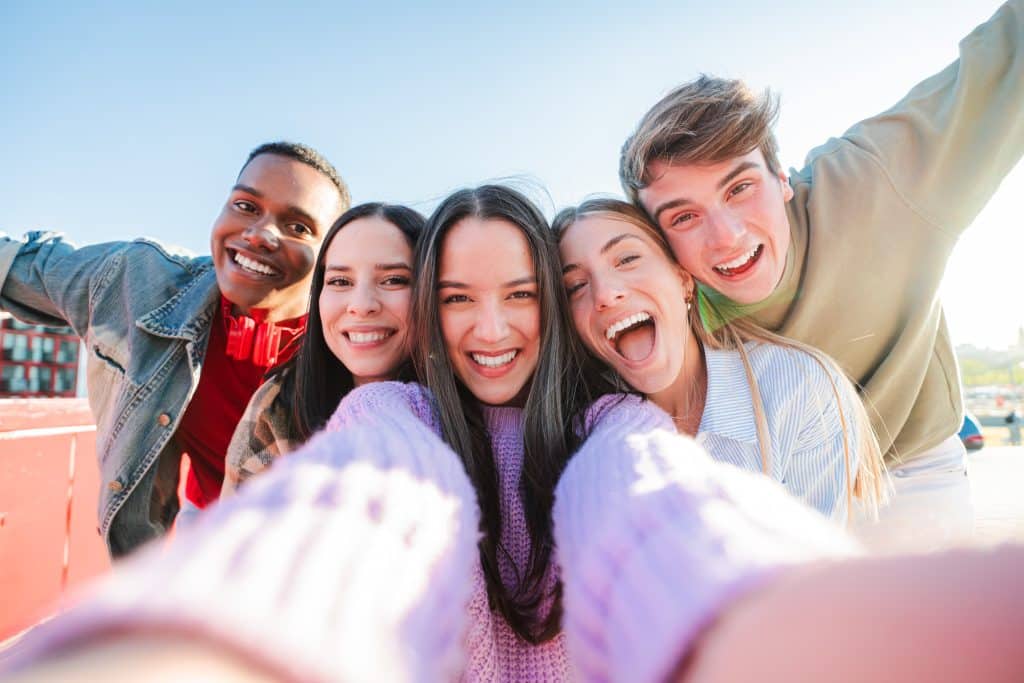 group of young people posing together for a selfie