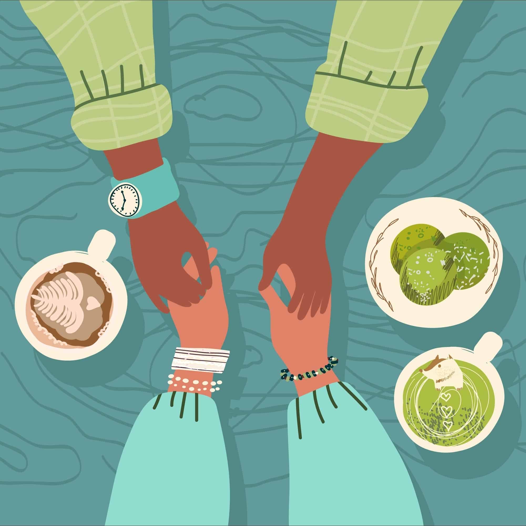 Two people holding hands over a coffee table.