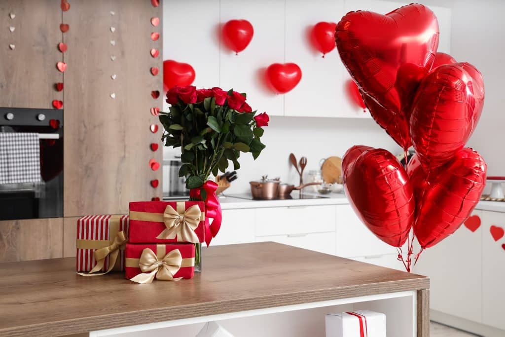 Gift,Boxes,And,Bouquet,Of,Roses,On,Wooden,Table,In
