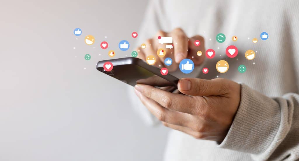 someone holding a phone with emojis shown in the photo