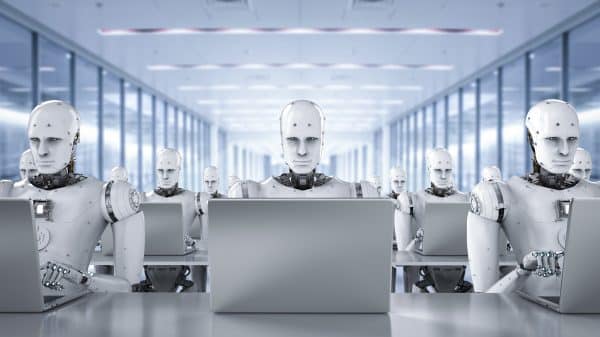 3D rendered image of humanoid AI robots working on laptop computers. Image: Shutterstock/Phonlamai Photo