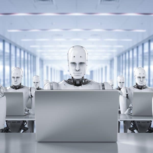 3D rendered image of humanoid AI robots working on laptop computers. Image: Shutterstock/Phonlamai Photo