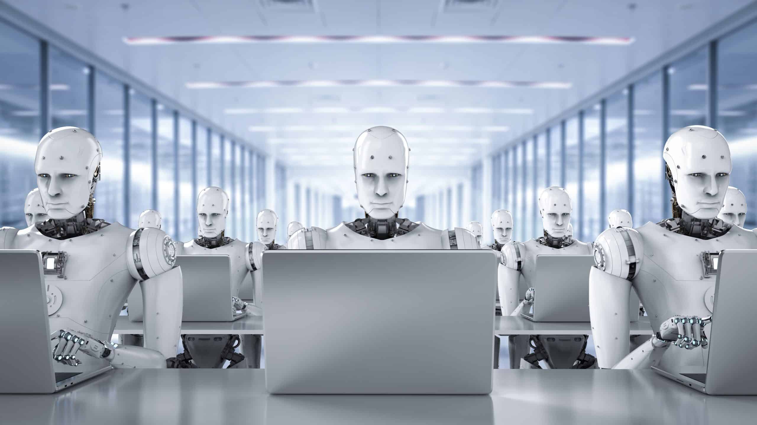 3D rendered image of humanoid AI robots working on laptop computers. Image: Shutterstock/Phonlamai Photo