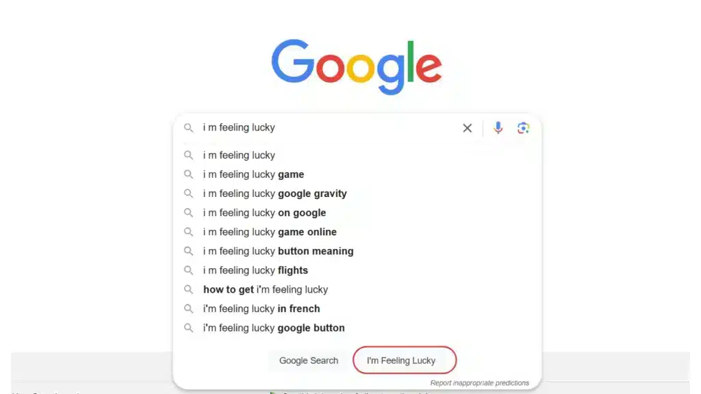 A screenshot of the Google homepage showing the search bar with the query 'I'm Feeling Lucky' typed in. Below the search bar, autocomplete suggestions related to 'I'm Feeling Lucky' are displayed, including 'I'm Feeling Lucky game' and 'I'm Feeling Lucky Google gravity.' The 'I'm Feeling Lucky' button is highlighted with a red outline at the bottom next to the 'Google Search' button.