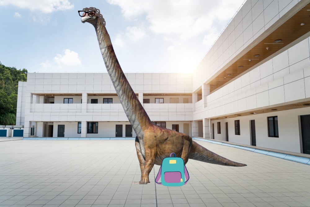 An image of a long-necked dinosaur with cartoon black glasses and drawn-on brown curly hair and a teal backpack at its feet. The dinosaur is standing in front of a white school building.