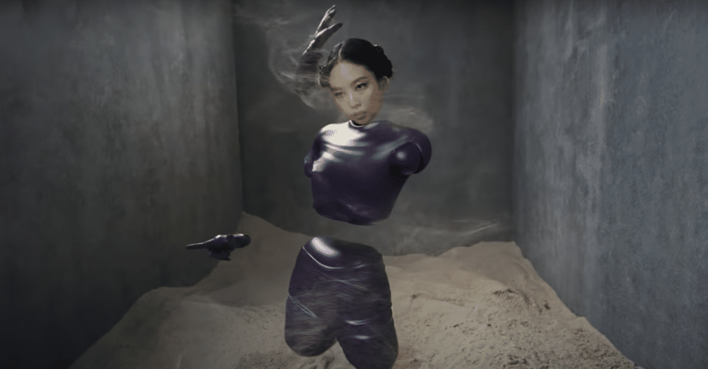 A screenshot of JENNIE as a futuristic creature in the "ExtraL" music video.
