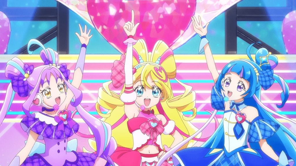Cure Kyun-Kyun, Cure Idol, and Cure Wink posing on stage.