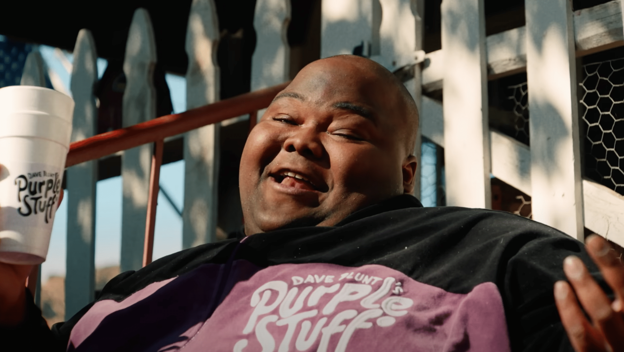 Dave Blunts holding a cup while smiling