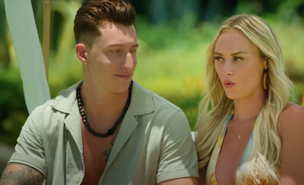 Ashley and Grant looking at each other with a funny look.