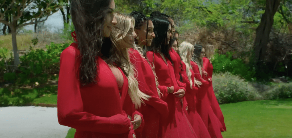 Female tempters in red robes ready to open them to show off their bikinis.