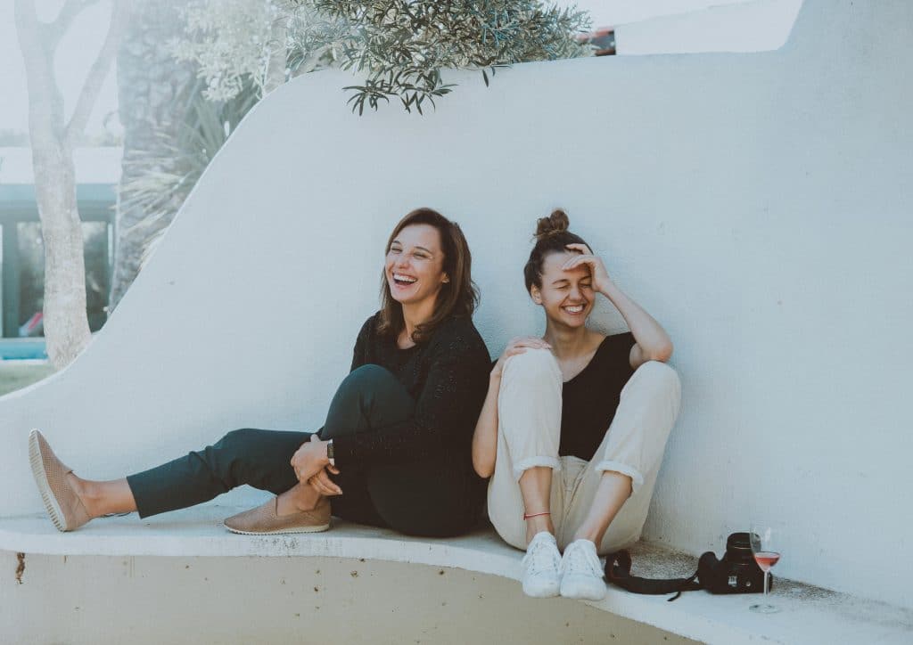 two women laughing outside