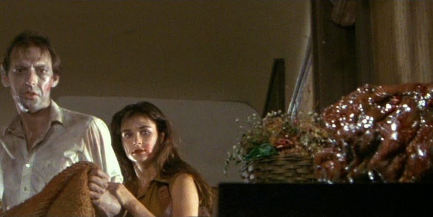 Robert Glaudin and Demi Moore look at one of the deadly parasites sitting on a countertop.