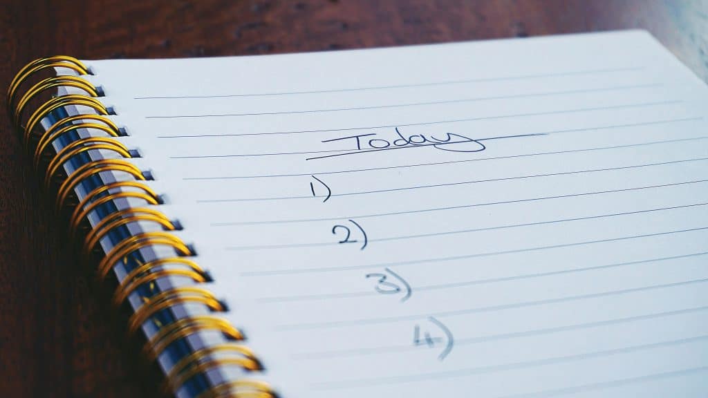 a to-do list written on a notepad.
