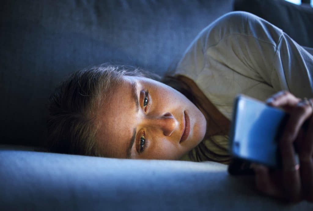 sadly scrolling in the dark, enforcing feelings of loneliness