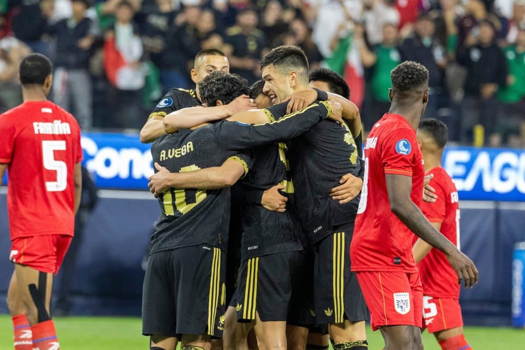 Mexican national team huddles together in a celebratory hug after scoring a goal on Panama.