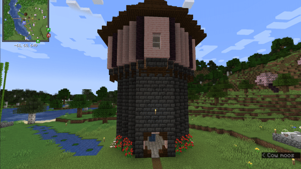 A tower made of deepslate bricks, cherry planks, and dark oak planks in Minecraft. A minimap from the Xaero's Minimaps mod is in the corner.