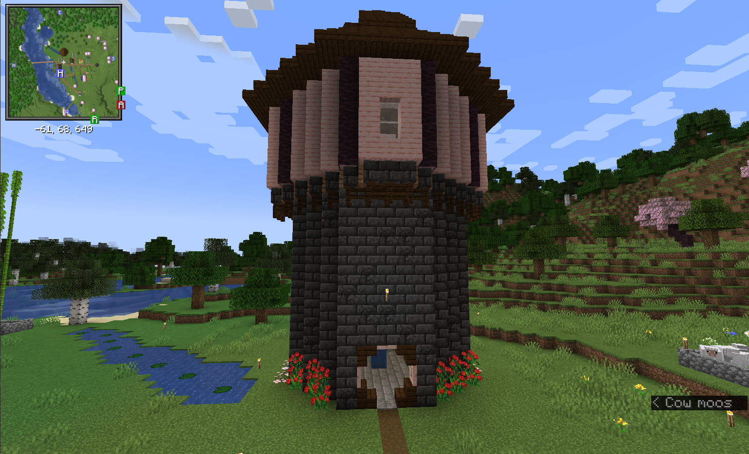 A tower made of deepslate bricks, cherry planks, and dark oak planks in Minecraft. A minimap from the Xaero's Minimaps mod is in the corner.
