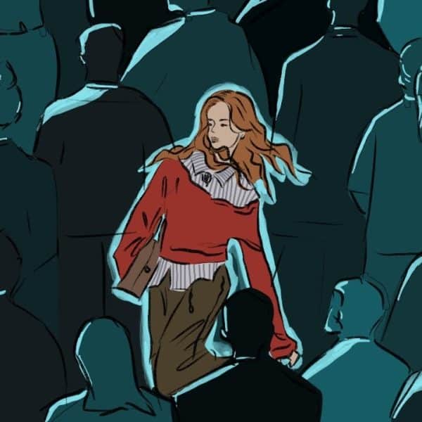Women in a sea of people and she is the only one in colour while the crowd is deep shades of blue.