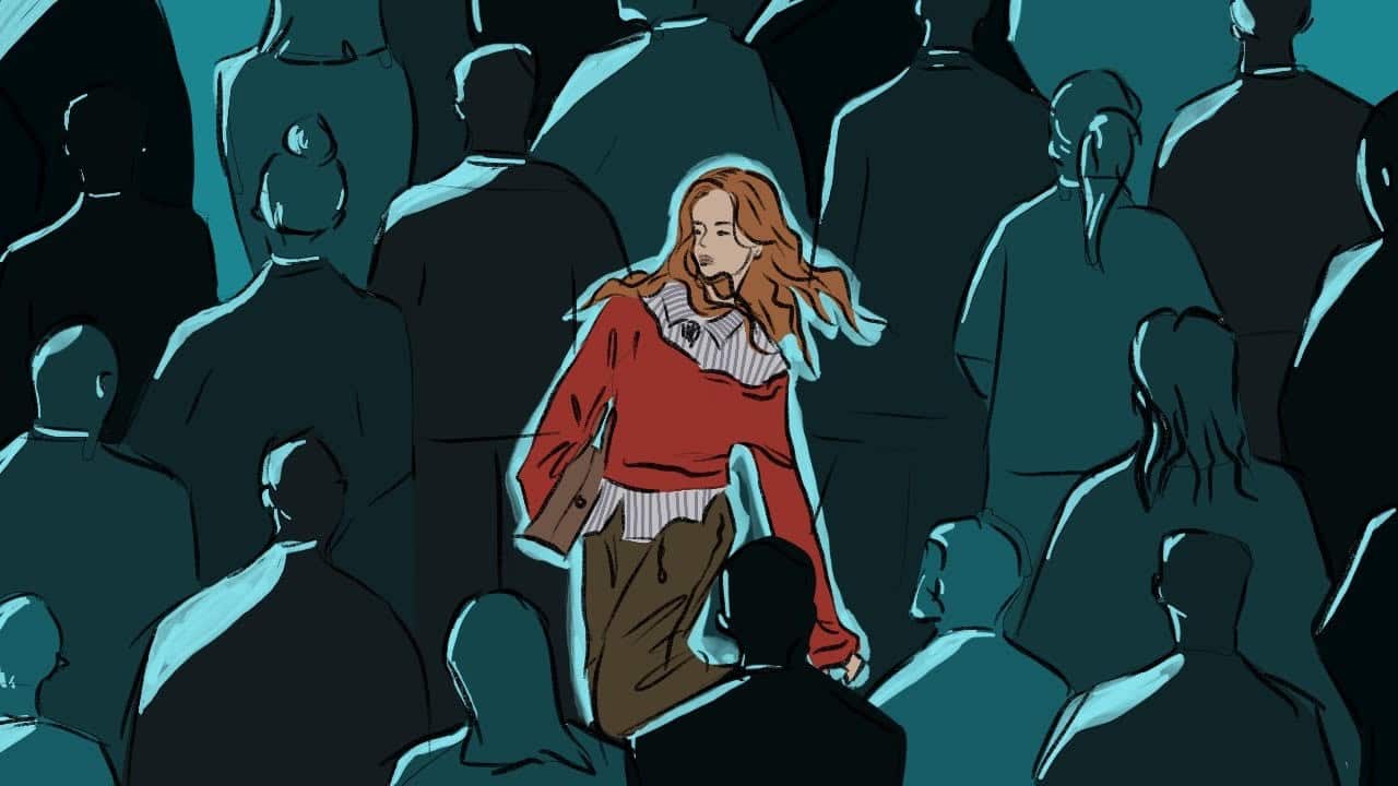 Women in a sea of people and she is the only one in colour while the crowd is deep shades of blue.