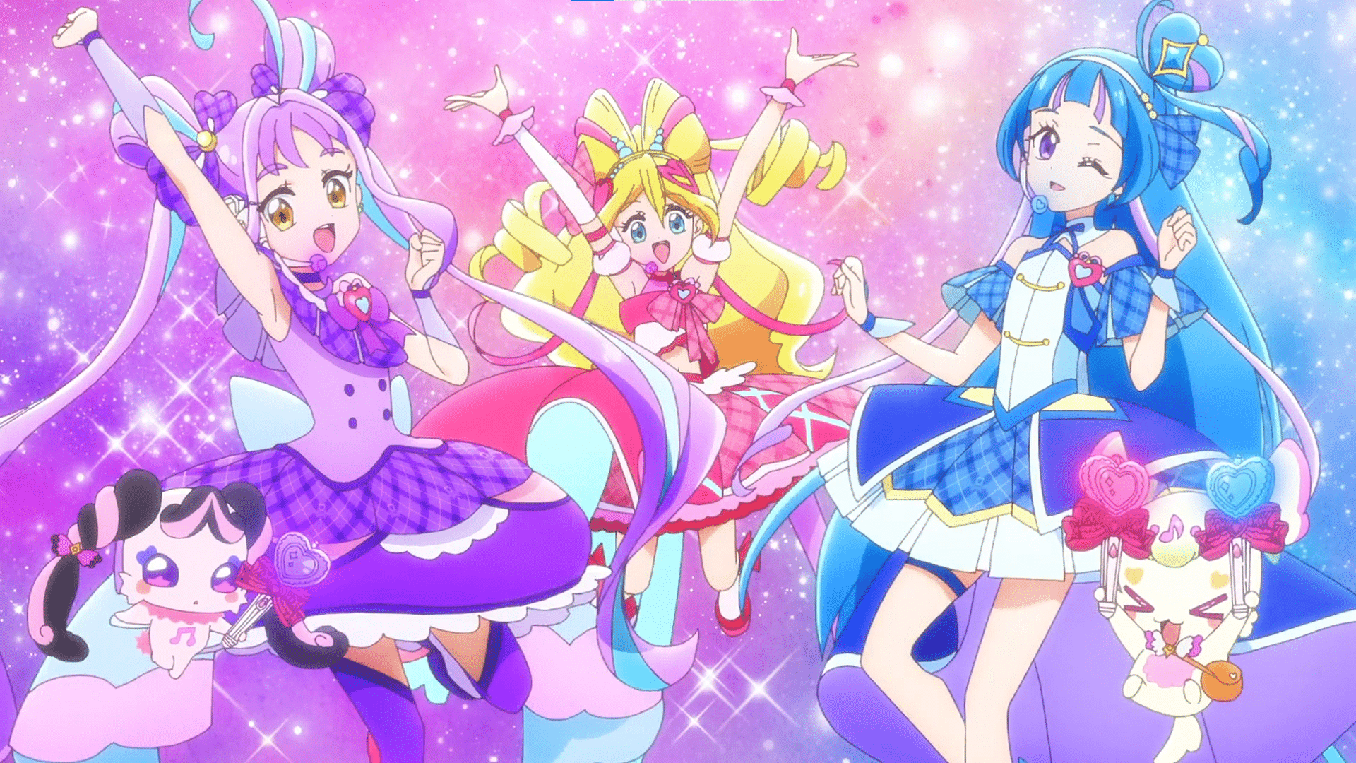 From left to right, Cure Kyun-Kyun, Cure Idol, and Cure Wink jumping against a sparkly background.