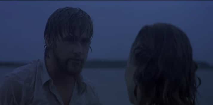 Man stares at the woman in front of him in a heavy rainstorm