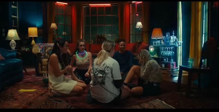 Group of young friends sit in their living room during a storm