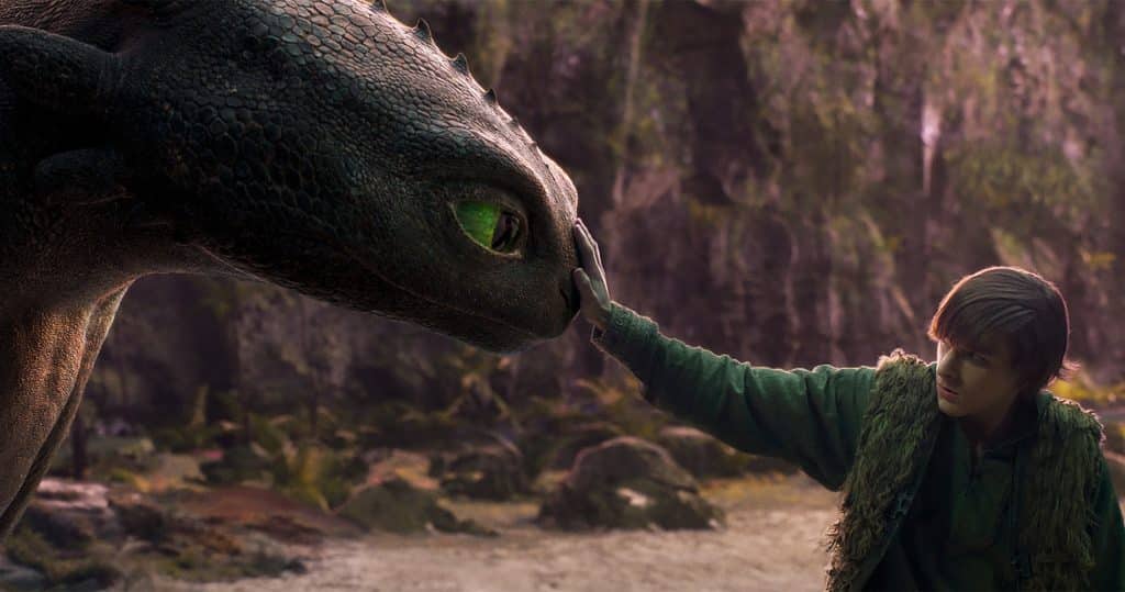 Mason Thames as Hiccup, petting Toothless in How To Train Your Dragon 2025