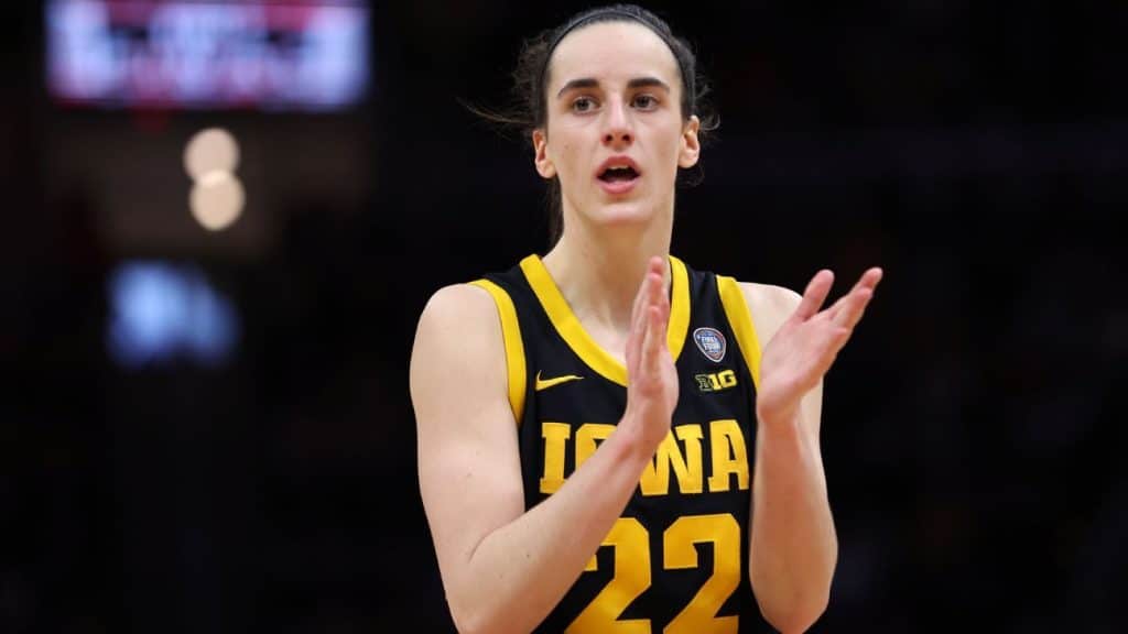 Caitlin Clark claps during a basketball game for the Iowa Hawkeyes.