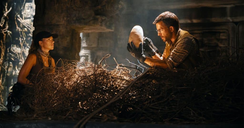 Scarlet Johansson and Jonathan Bailey marveling at a dinosaur egg in Jurassic World Rebirth 2025