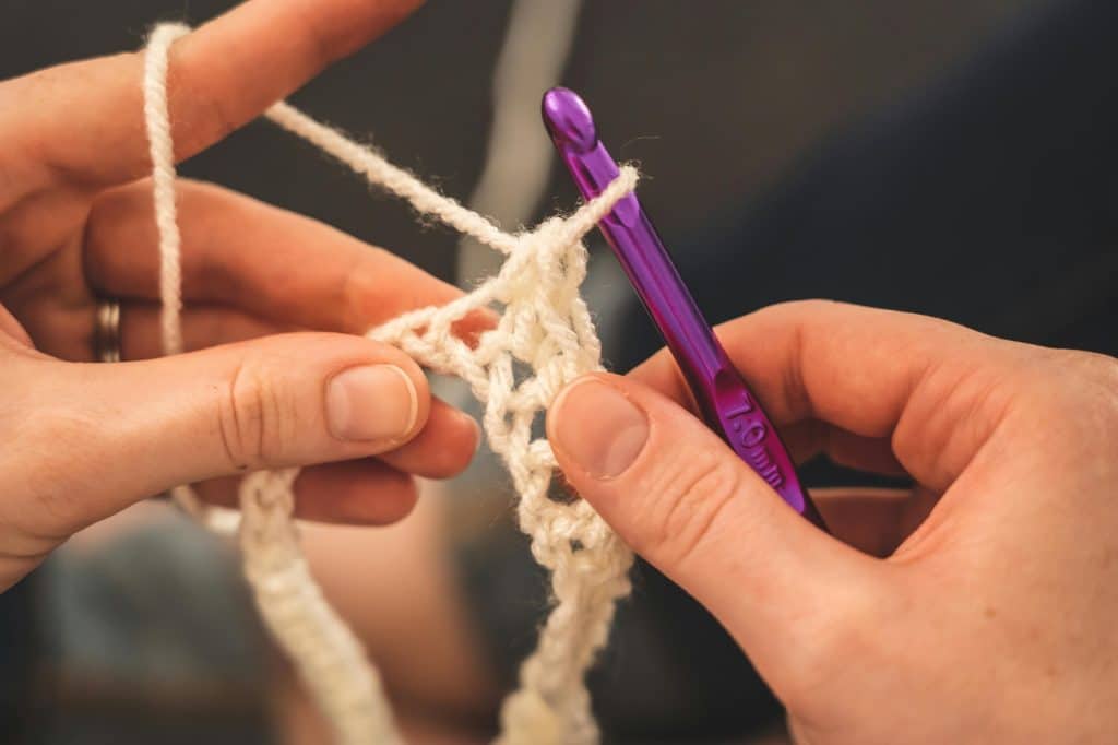 Someone creating a comfy crochet sweater